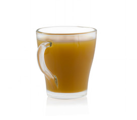 Yellow juice in a glass cup on a white background without shadow