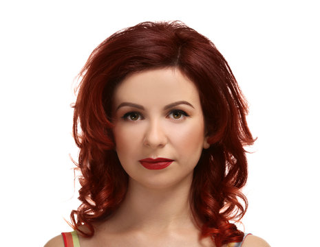 Beautiful young woman with dyed curly hair on white background