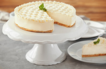 Delicious plain cheesecake on white stand