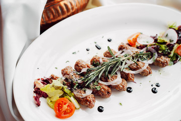 Delicious Chevanchichi sausages on white plate