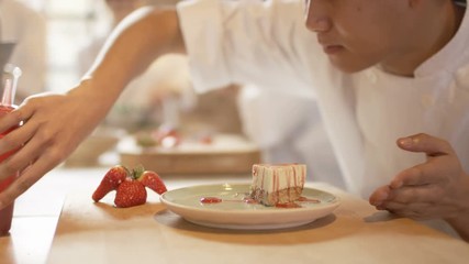  Portrait smiling young chef giving finishing touches to dessert