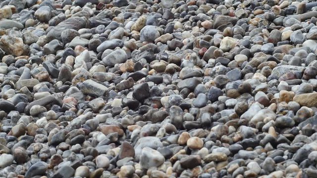 water through pebbles on beach