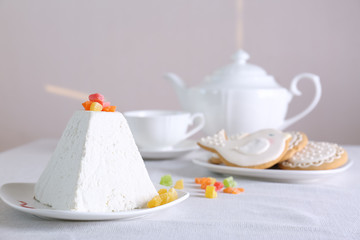 Traditional curd Easter cake with candied fruits on light table