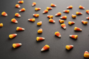 Tasty Halloween candies on dark background
