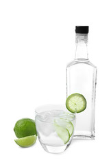 Glass and bottle of tequila on white background