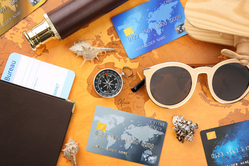 Credit cards with passport and ticket for vacation on world map background