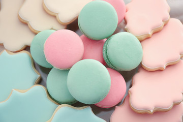 Tasty macarons and cookies prepared for party, closeup