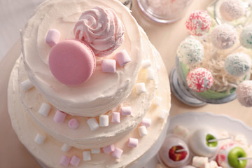 Tasty cake with sweets on table, closeup