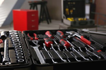 Box with special tools in car repair shop, closeup