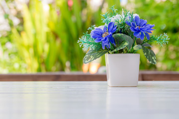 Flower bouquet  on wooden table. With garden in background
