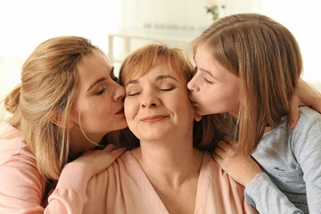 Happy mature woman with her family at home