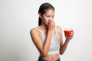 Young Asian woman hate tomato juice.