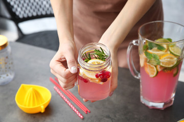 Young woman with lemonade at home, closeup