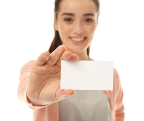 Beautiful young woman with business card on white background, closeup