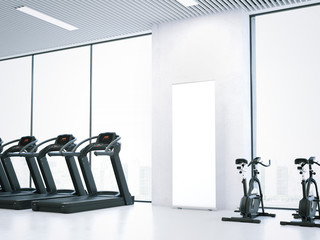 Fototapeta premium Treadmills, bicycle simulators and blank roll-up bunner. 3d rendering