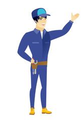 Asian mechanic showing a direction.
