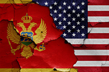 flags of Montenegro and USA painted on cracked wall