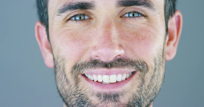 A beautiful portrait of man smiles and shines his white teeth and his skin smooth and perfect. concept: beauty, cream, beauty