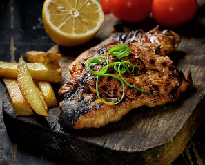 Steak with herbs on a wooden background