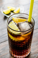 Cuba Libre Cocktail with lime and ice.
