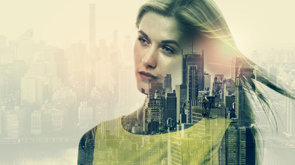 Double exposure of young woman and skyscrapers