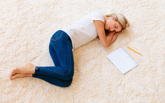 Young Woman Lying Down On Carpet