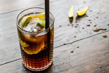 Cuba Libre Cocktail with lime and ice.