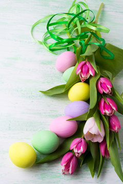 Easter arrangement with painted eggsand green ribbon