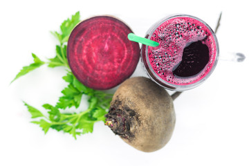 Beet smoothie with grapefruit and parsley on wooden table top view.