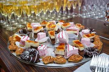 Different delicious desserts and cakes on table