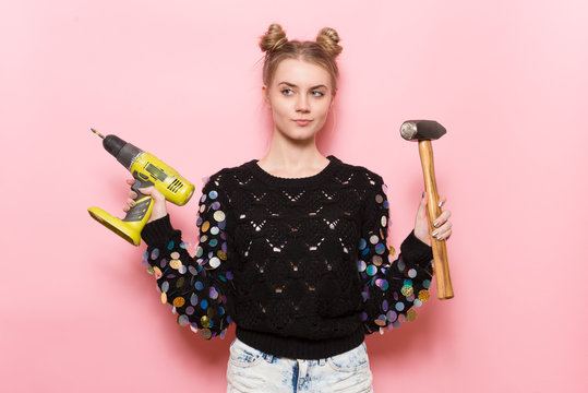 cute young adult woman holding working tools in hands.
