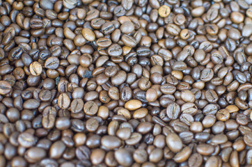 The Indian black coffee beans fried by a scattering on a market counter
