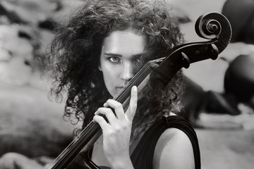 beautiful young woman playing cello outdoors © zolotareva_elina
