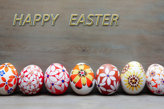 Easter eggs painted by hand on a wooden background