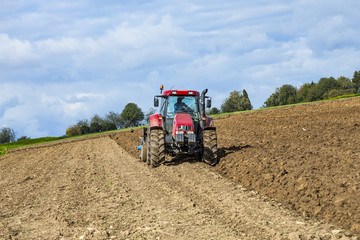 tractor is plowing the field