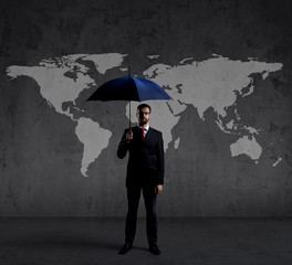 Businessman with umbrella standing over world map background. Business, risk, insurance, concept.