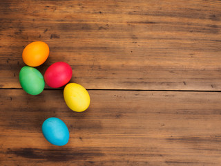 Easter eggs on old brown wood background. Top view, horizontal. Mock up for your greetings card, poster or other design. Russian and Ukrainian, orthodox, slavic traditional Easter, rural background.