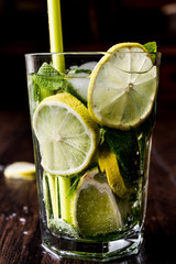 Mojito cocktail with lime, mint leaves and ice.
