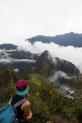 Fototapeta na wymiar young Woman enjoying view of Machu Picchu citadel in Peru