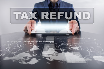 Businessman using tablet pc and selecting tax refund.