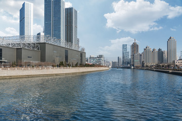 River And Modern Buildings Against Sky,reflection of cityscape in river,shot in Shanghai,China.