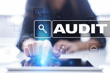 Woman using tablet pc, pressing on virtual screen and selecting audit.