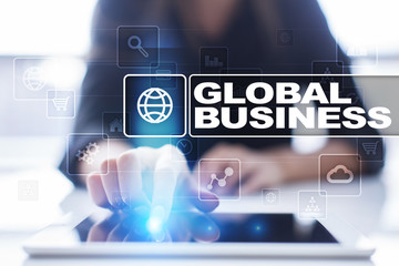 Woman using tablet pc, pressing on virtual screen and selecting global business.