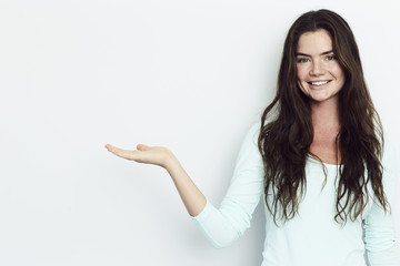 Portrait of beautiful brunette gesturing to camera