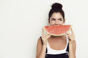 Watermelon smile on young woman, looking away