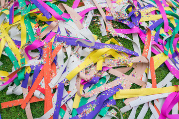 Wind with Colored papers placed on a grave during Qingming Festival at chinese cemetary