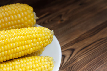 Fresh hot corn on cobs on rustic wooden table, closeup. Selective focus