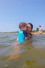 Mixed race family play at the beach