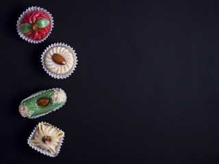 small oriental sweet cakes made of baked marzipan isolated on black background