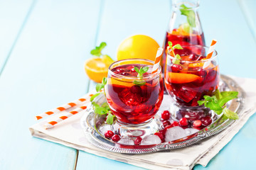 Summer drink Sangria with orange and cranberry. Selective focus. Copy space